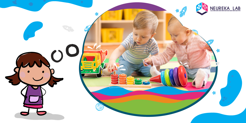 Infants jugant a organitzar peces de colors.